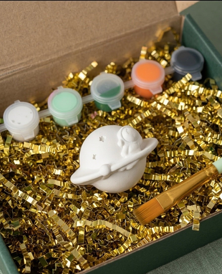 Paintable ceramic astronaut figurine kit with paintbrush and assorted paint colors