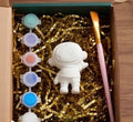 Paintable ceramic astronaut figurine kit with paintbrush and assorted paint colors