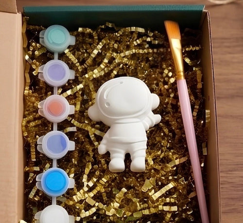Paintable ceramic astronaut figurine kit with paintbrush and assorted paint colors