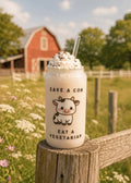 Frosted can cup with text "Save a cow eat a vegetarian" with a cute cow design. 