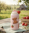 Frosted can cup with a highland cow and strawberry design. 