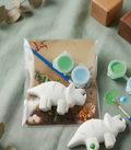 Paintable ceramic triceratops figurine kit with paintbrush and assorted paint colors