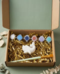 Paintable ceramic dolphin figurine kit with paintbrush and assorted paint colors