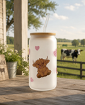 Frosted can cup with a heart and highland cow design.