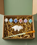 Paintable ceramic dinosaur figurine kit with paintbrush and assorted paint colors