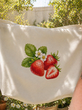 White tote bag with strawberry design.