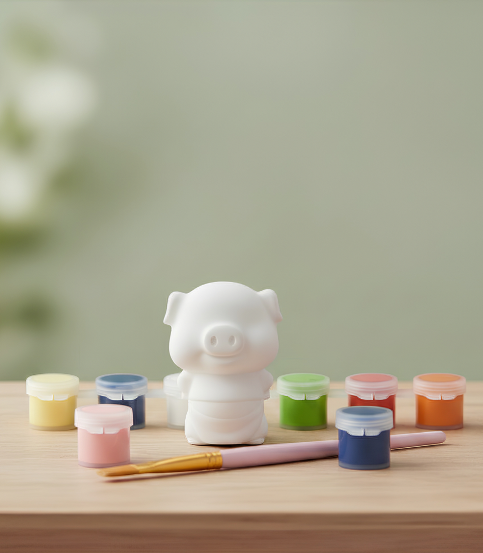 Paintable ceramic pig figurine kit with paintbrush and assorted paint colors
