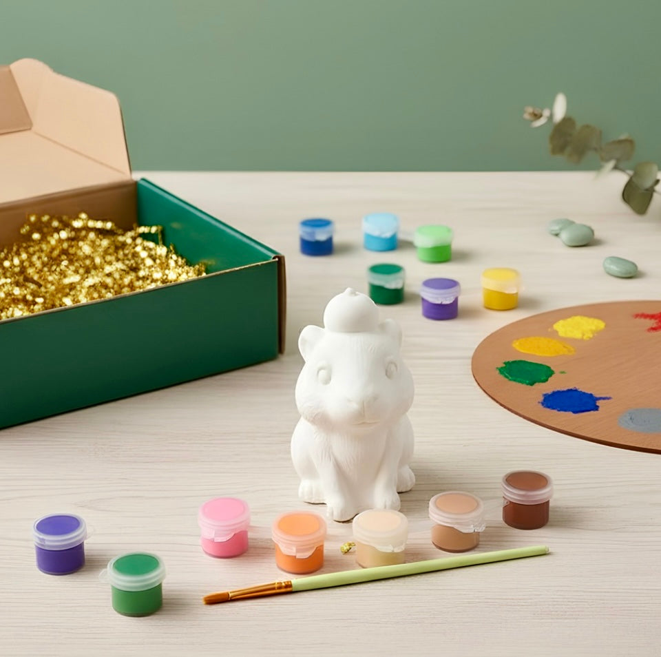 Paintable ceramic capybara figurine kit with paintbrush and assorted paint colors
